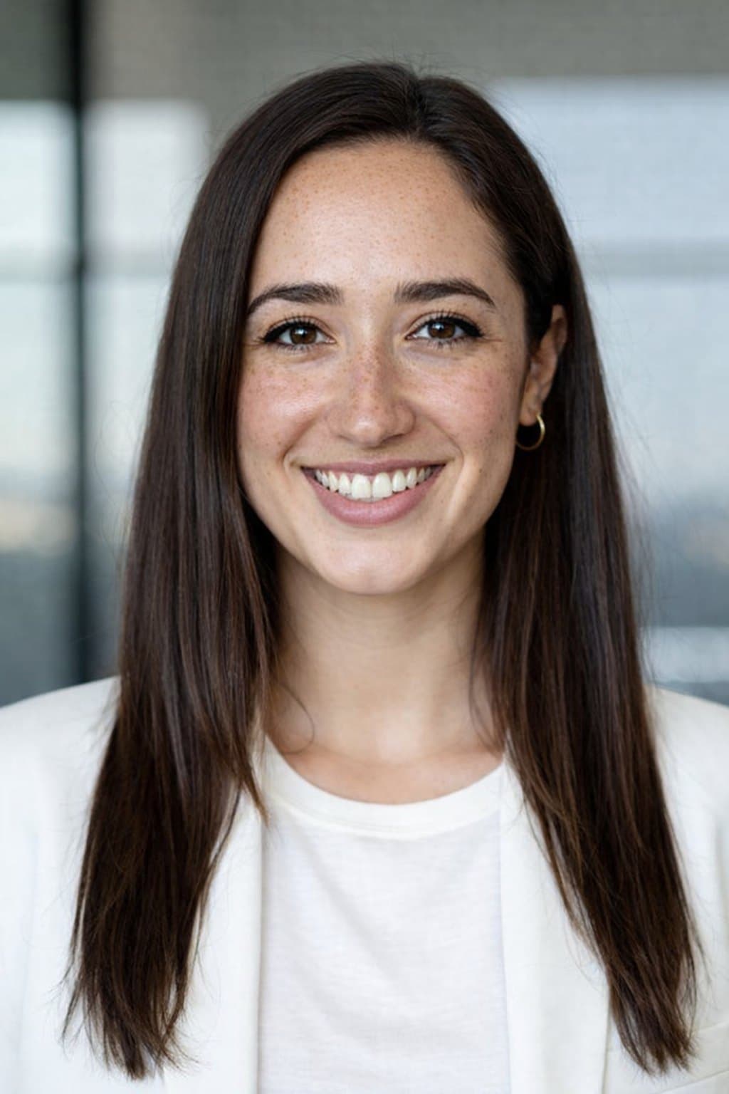 Portrait of Dr. Maya Reynolds, PsyD, smiling in a white blazer